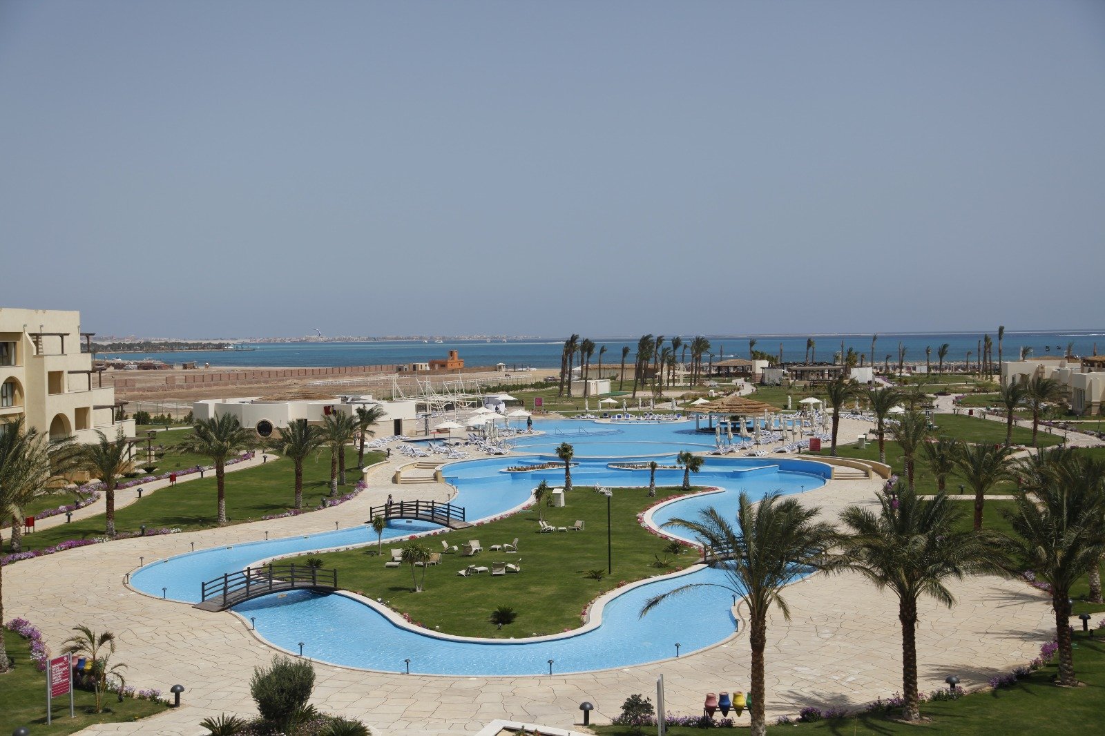 Resort swimming pool complex with palm trees and a lagoon layout